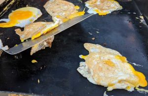 Frying Eggs for Tailgate Breakfast Sandwiches