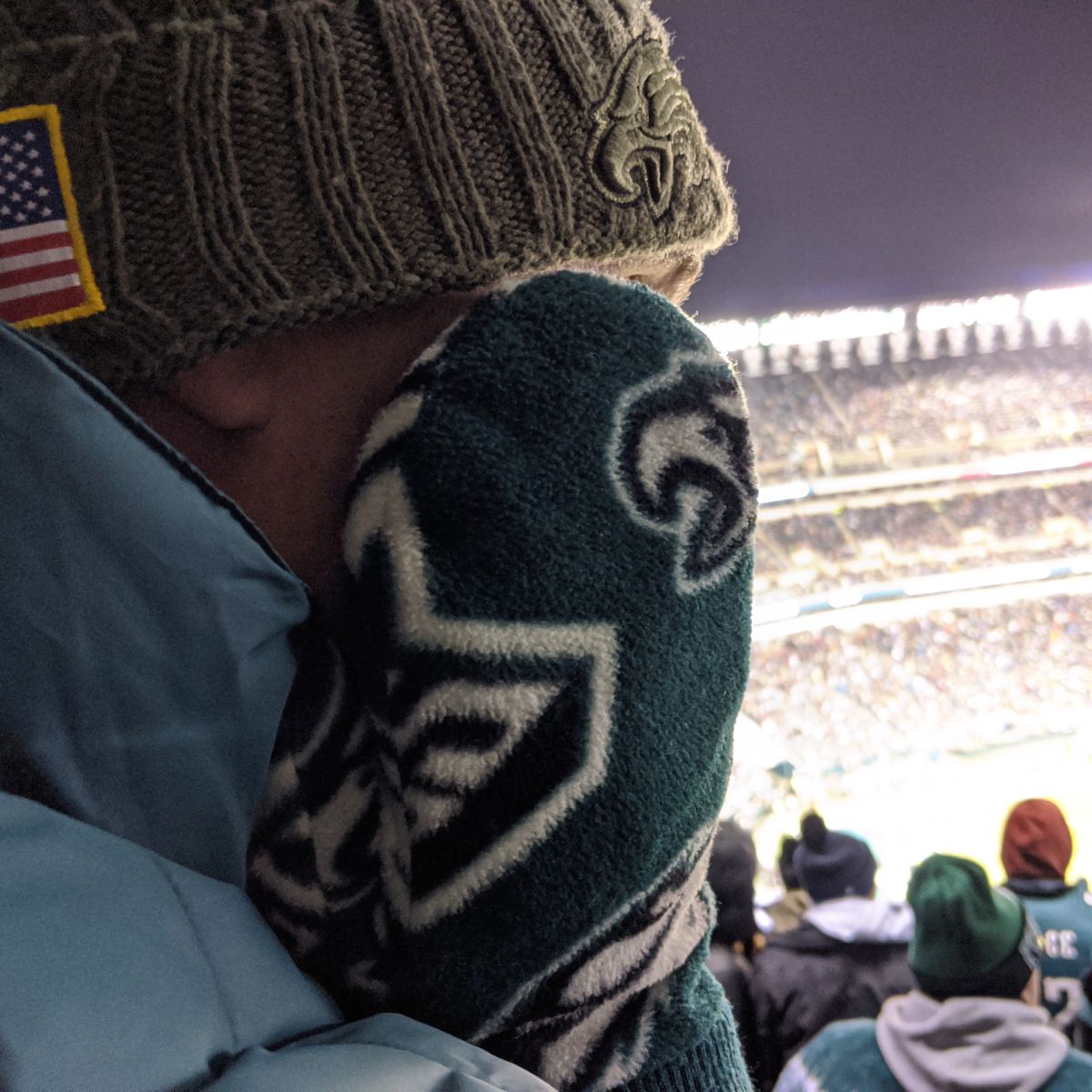 Cold guy at Eagles game wearing hat and mittens